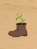 Affiche minimaliste beige : une vieille chaussure montante brune à lacets posée sur un sol de sable, d'où sort une jeune pousse verte à quelques feuilles